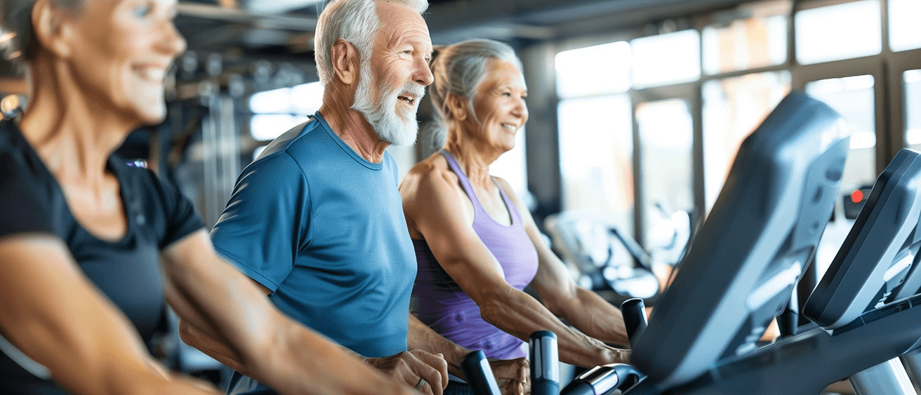 BE_old_aged_happy_senior_couple_doing_sports_in_a_gymnastics_studio_AdobeStock_920687017_1312x563